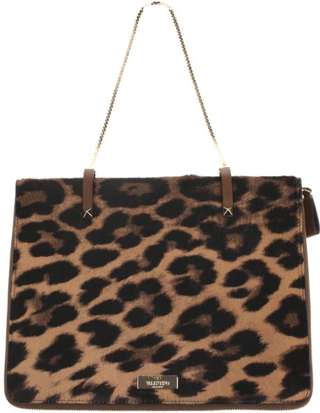 Multicolored structured leather bag with ponyskin leopard-print finish. Yves Saint  Laurent bag has a black suede trim and lining, black leather top handle and.