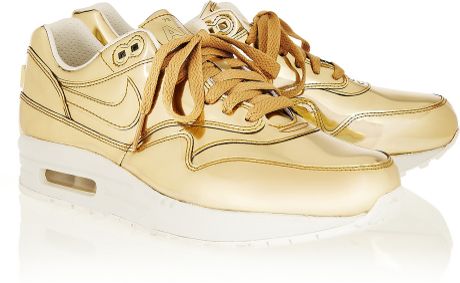 gold and white nike sneakers