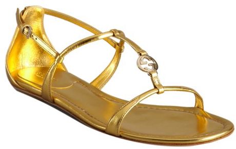 gold strappy gucci sandals metallic charm leather