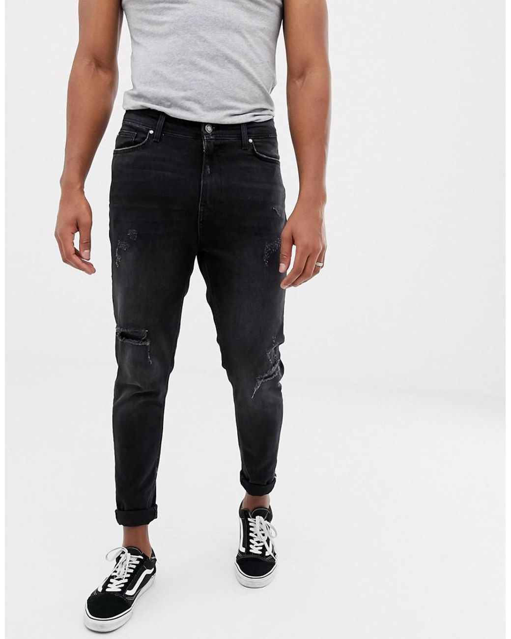 Lyst - Bershka Carrot Fit Jeans In Black With Rips And Hem Taping in ...