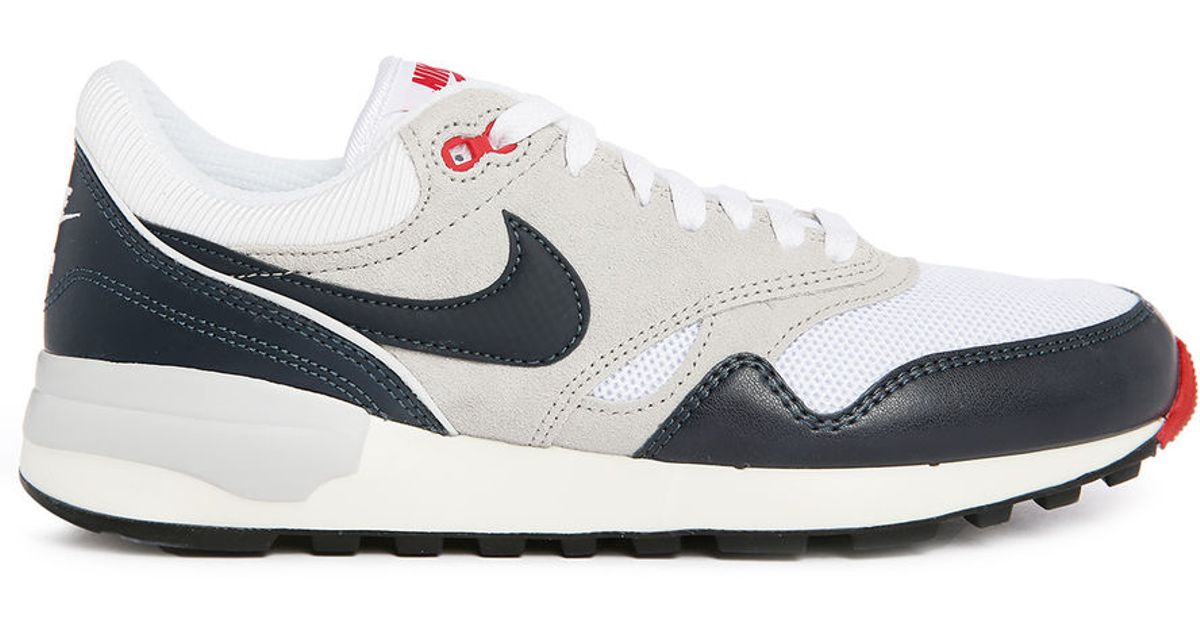 nike white sneakers with blue logo