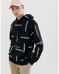 tuta nera e oro converse