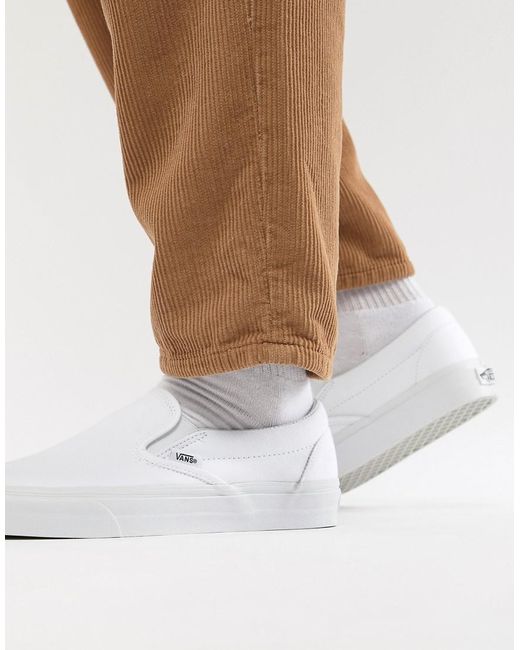 tan and white slip on vans