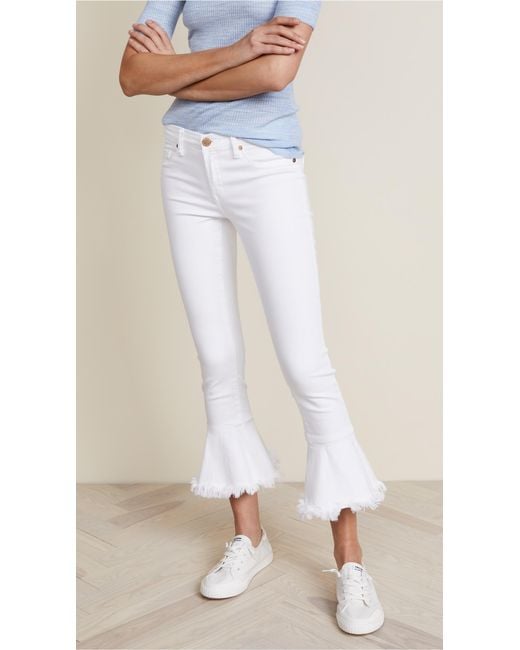 white flare ripped jeans