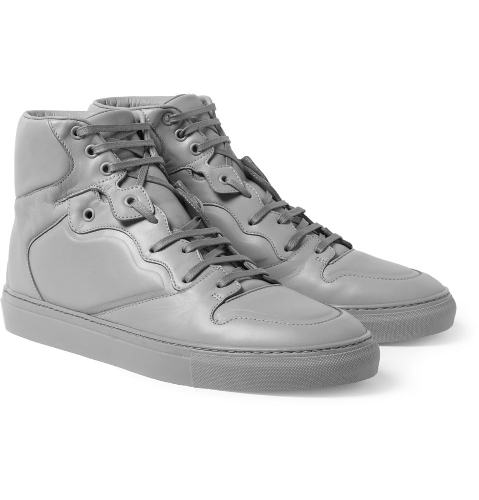 Seller information Men's white patent leather Balenciaga round-toe high-top sneakers with PVC side panels, translucent rubber soles and lace-tie closures.