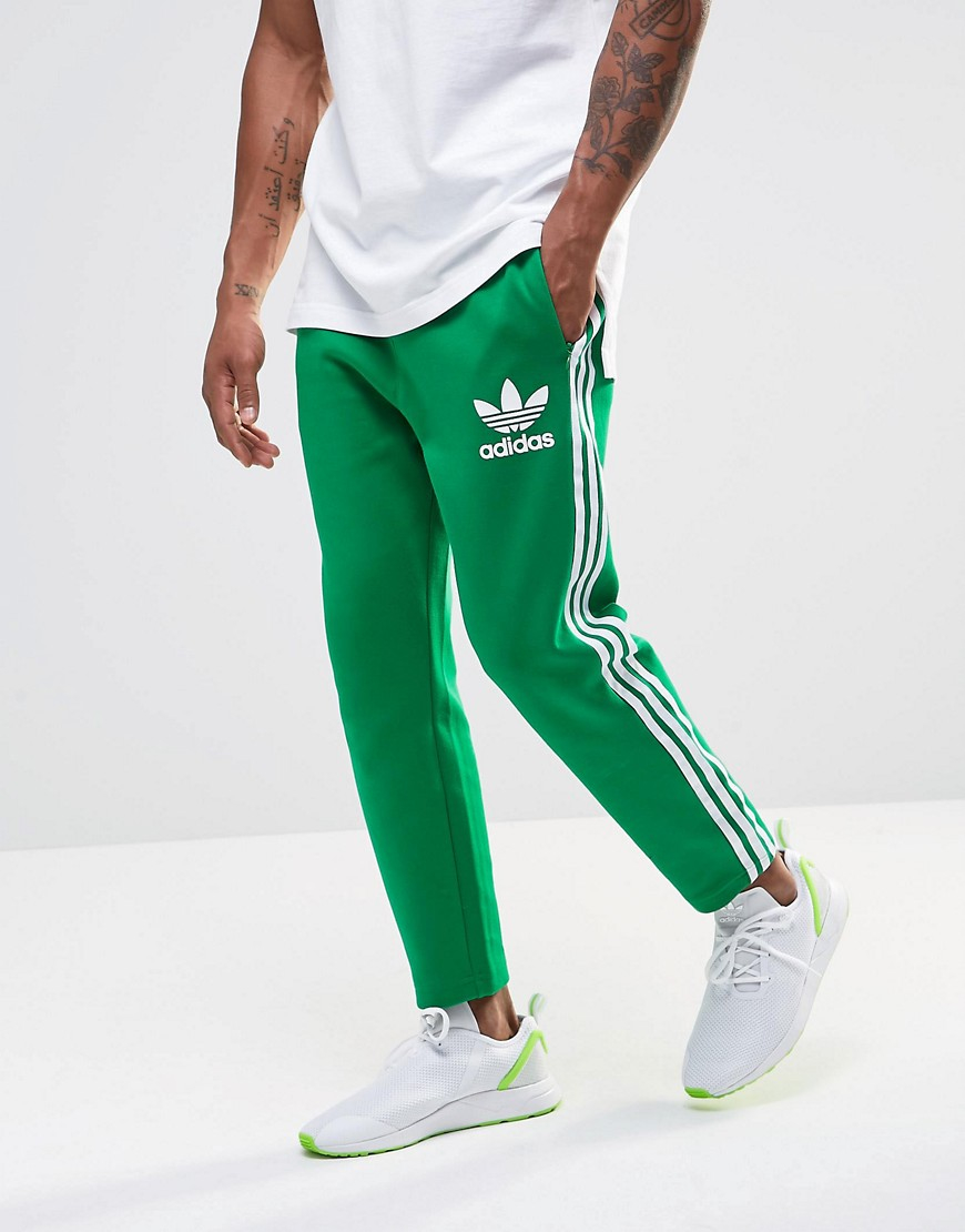 green and white adidas pants