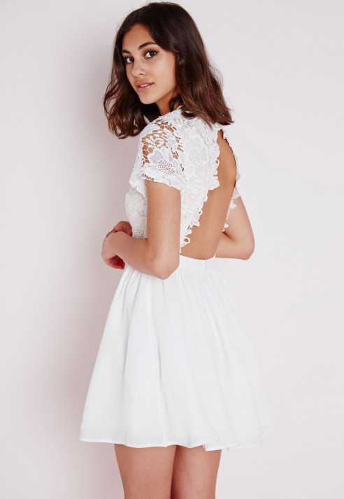 The Lulus Reach Out My Hand White Lace Skater Dress will be there for any fashion emergency! This medium-weight stretch knit dress has a high halter neckline and fitted bodice with princess seams. Panels of sheer lace accent the waist and hem of the flirty skater skirt. Hidden back zipper/5(57).