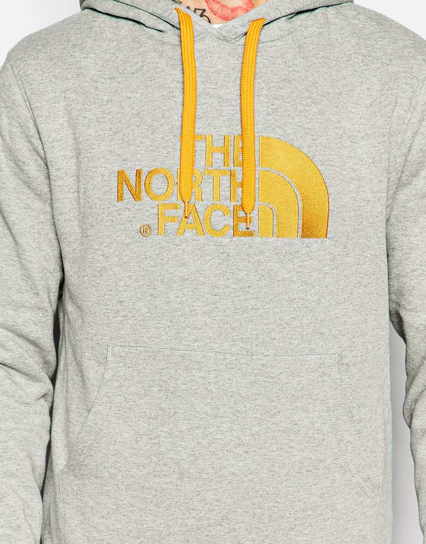 grey and yellow north face hoodie