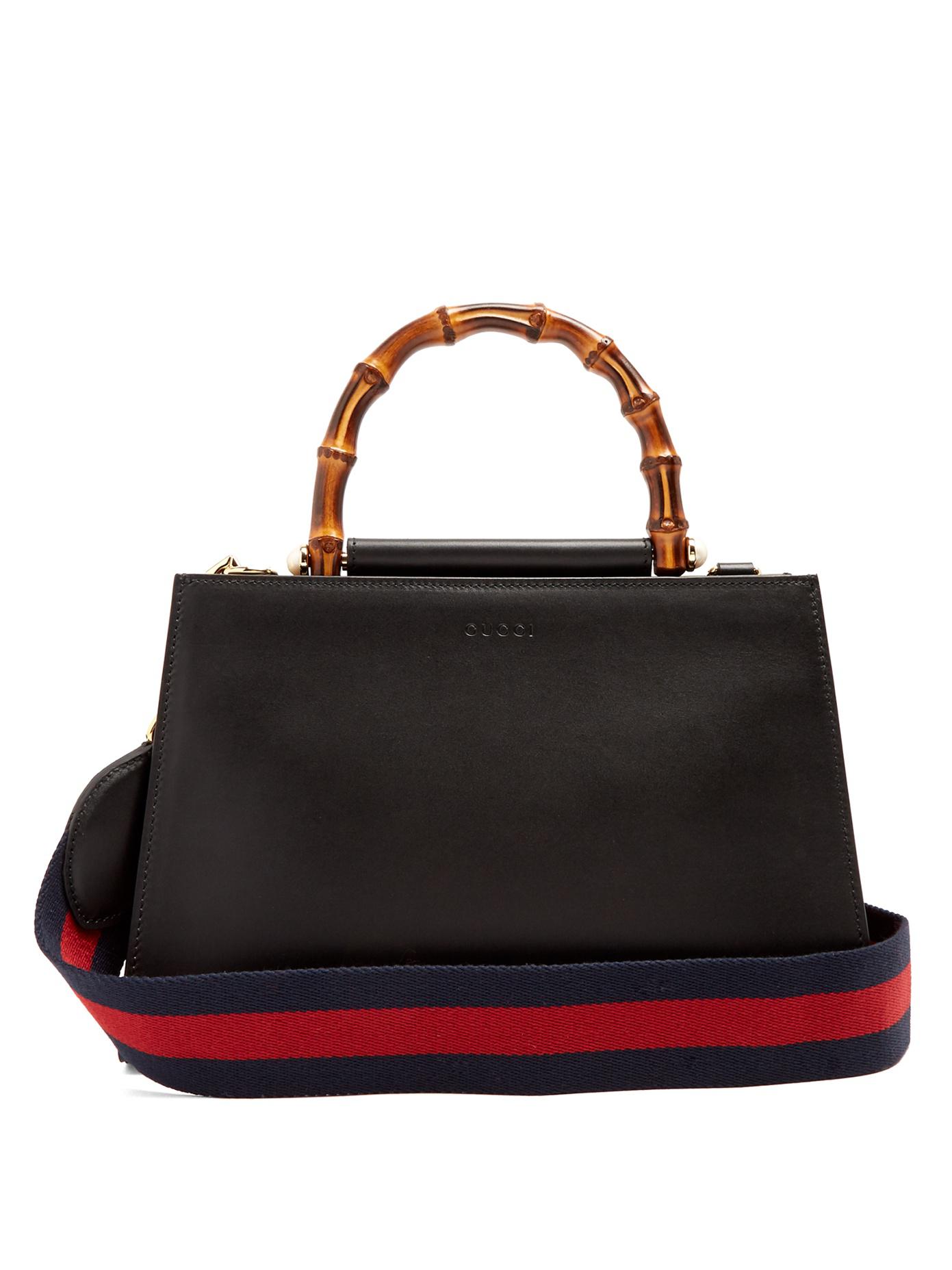 black gucci handbag with red and green strap